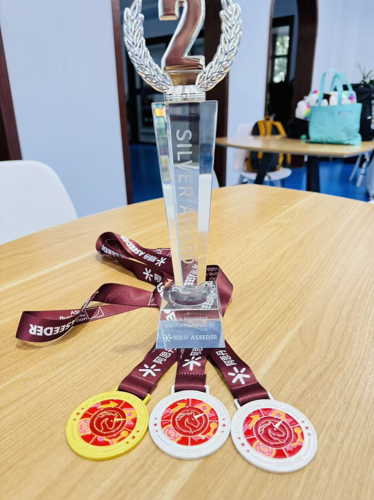 Silver Award trophy with three ASEEDER medals on table