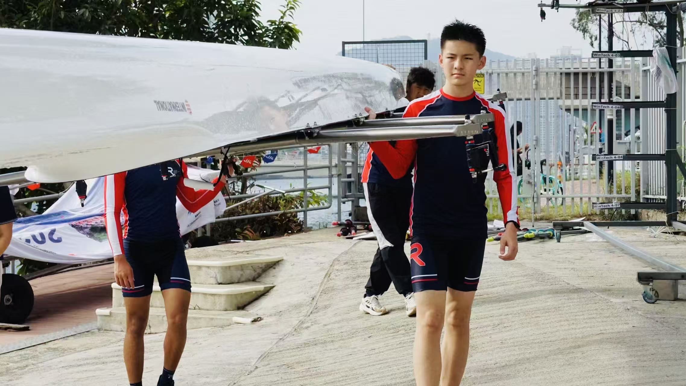 Athlete carrying the quad to the water — race day preparation